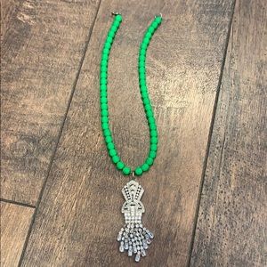 Green beaded necklace with crystal pendant
